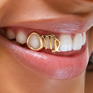 Custom Virgo zodiac grillz worn on a smile